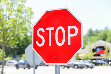 Red stop sign signifies caution, safety, control, and the imperative to pause or halt in order to...