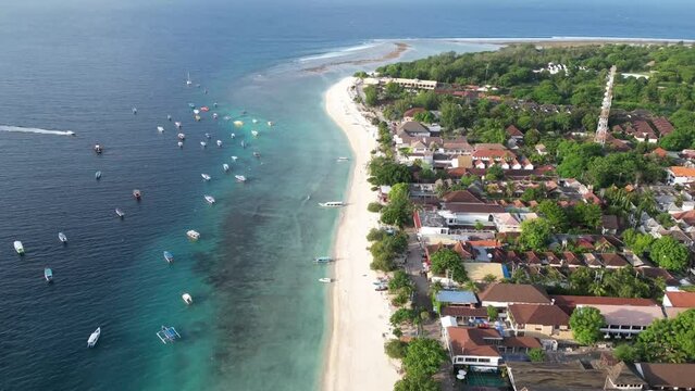 Aerial Hyperlaps of Gilli Trawangan coastline with colorful boats floating on the turquoise coastline