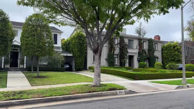 Beverly Hills homes POV in wealthy real estate neighborhood, Los Angeles