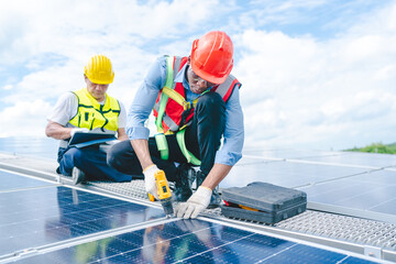 African American engineer maintaining solar cell panels on factory building rooftop. Technician working outdoor on ecological solar farm construction. Renewable clean energy technology concept