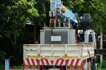 power transformer strapped on truck and crane arm