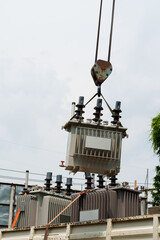 Crane hook lifts up distribution transformer