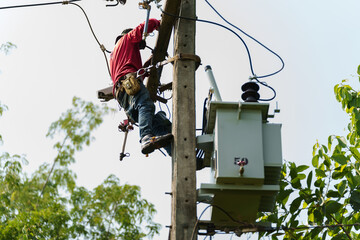 worker install a three-phase current transformer on electric pole