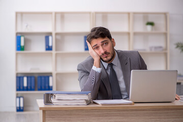 Young male employee working in the office