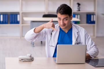 Young male doctor in telemedicine concept