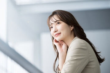 Image of a handsome woman in a cool suit working in an office looking at her goals and future. For...