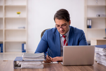 Young male employee working in the office