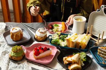 A variety of desserts and salads on table
