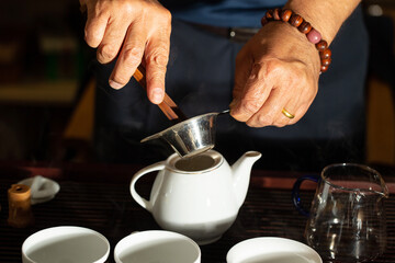 Fototapeta na wymiar pouring tea into a teacup 
