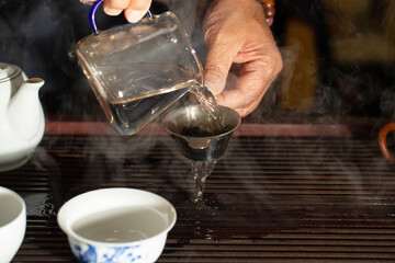 pouring tea into a teacup	