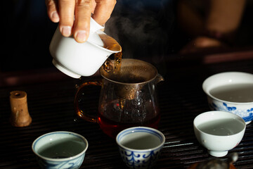 pouring tea into a teacup	