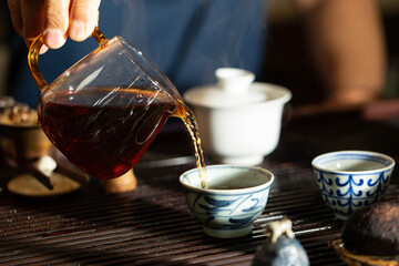pouring tea into a teacup