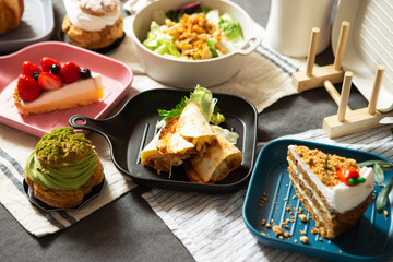 A variety of desserts and salads on table	
