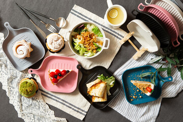 A variety of desserts and salads on table	