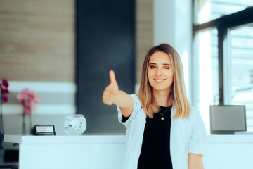 Doctor Making a Thumbs Up gesture Standing in Clinic Reception. General practitioner welcoming her...