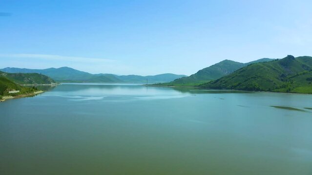 Aerial bird's-eye view of a huge reservoir among the mountains, bright sunny day, Bukhtarma reservoir, beautiful nature of east Kazakhstan