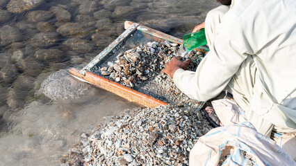 Sorting and picking of valuable stones from the excavations debris of swat emerald mine in swat...