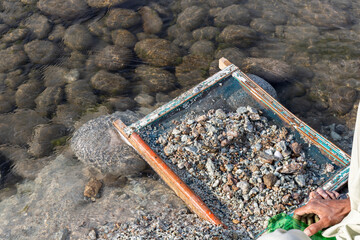 Searching for gemstones in the gravel near the extraction of mine minerals site