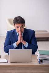 Young male employee working in the office