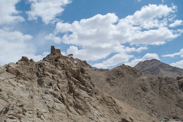 The barren landscape of Leh, Ladakh. Landscape view of rocky land surrounded by Himalayas Dramatic clouds. 