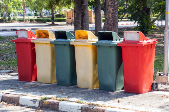 Garbage trash bins multicolor red, yellow, green, in urban city for waste sorting and separation management. 