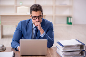 Young male employee working in the office