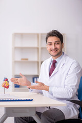 Young male doctor cardiologist working in the clinic