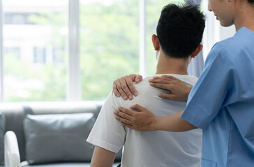 A physiotherapist or medical professional doing physiotherapy on the back scapula and back injury of male athlete patient stretching and exercise cause pain rehabilitation therapy, health insurance.