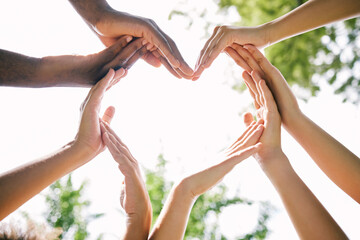 Hands, heart and emoji with a group of people outdoor together in summer for love or solidarity....