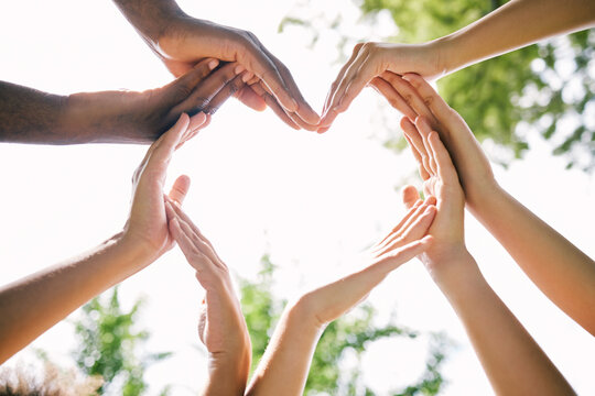 Hands, heart and emoji with a group of people outdoor together in summer for love or solidarity. Social media, icon and hand gesture with friends outside in nature for sustainability or bonding