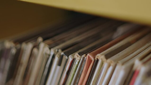 View of an old CD covers organised neatly side-by-side. Selective focus , close-up shot. 