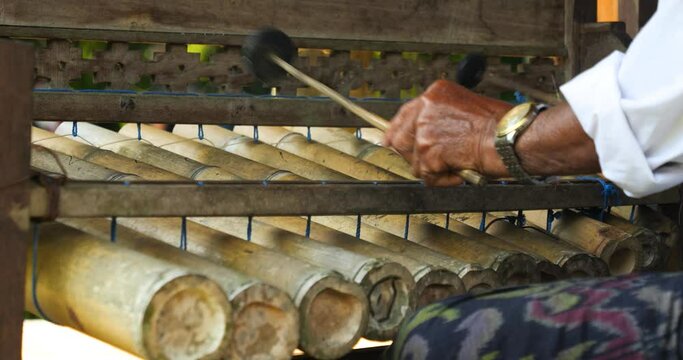 Slow motion close up of Rindik an instrument made of bamboo canes from bali indonesia in ubud while a musician plays it