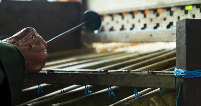 Close uo slow motion shot of a rindik an instrument made of bamboo canes played by a balinese musician