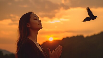 Hope idea with praying woman and free bird taking in the scenery against a sunset background. GENERATE AI