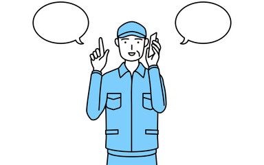 電話をしながら指さしをする帽子と作業着姿のシニア男性（経営者、管理職、上司）