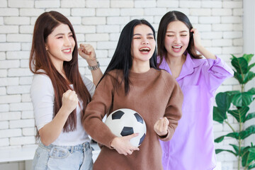 Millennial three Asian beautiful cheerful excited female girlfriends in casual outfit standing...