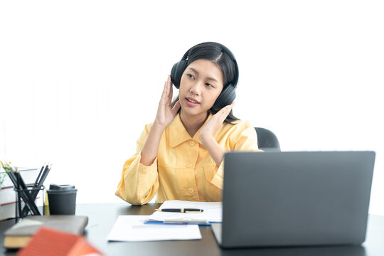 Attractive Young Asian Business Woman Relaxing From Work During Break Listening To Music And Having Fun. On White Background