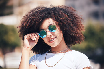 Woman, fashion and sunglasses on face outdoor in city for summer holiday and travel with a smile....