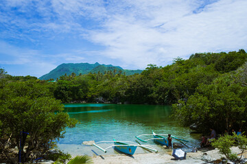 Kids rowing on a boat along the lake. Tinagong Dagat, Calatrava, Romblon, Philippines