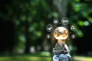 light bulb on pile of coins concept renewable energy energy crisis clean energy green business that...