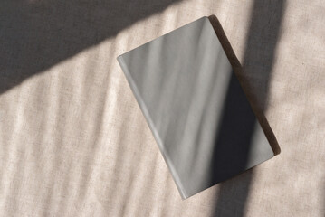 Minimalist neutral business branding template, gray notebook or book with blank cover on beige...