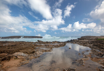 Clouds reflecting while storm waves crash into Laie Point coastline at Kaawa on the North Shore of Oahu Hawaii United States