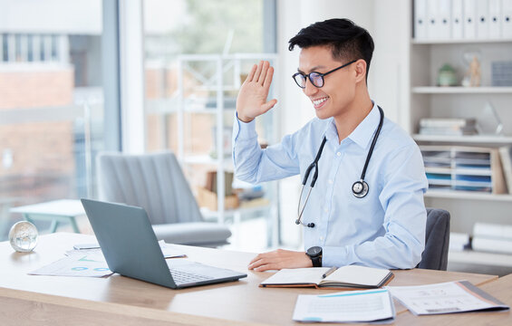 Medical, video call and telehealth with an asian man doctor in his office at the hospital for remote consulting. Healthcare, virtual and wave with a young male medicine professional working online