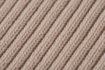 knitted pattern, beige woolen sweater texture background.