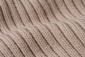 knitted pattern, beige woolen sweater texture background.
