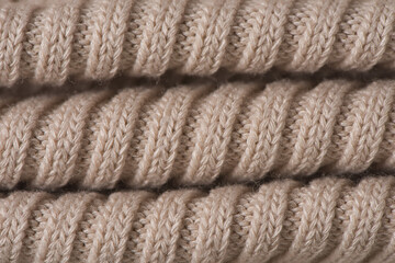 knitted pattern, beige woolen sweater texture background.