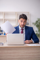 Young male employee working in the office