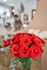 Florist at work. Summer bouquet of roses. Learning flower arranging, making beautiful bouquets with your own hands. Flowers delivery