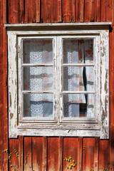 Window on a red wooden cottage