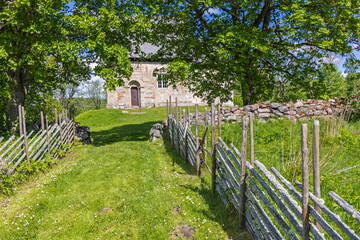 Footpath with wooden pole fence to Suntak's old church in Sweden